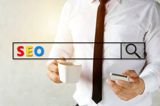 SEO, Search Engine Optimization concept. Businessman are using smartphones to find information and drinking coffee, Graphic Search and Magnifier. Sunlight shines down to warm.